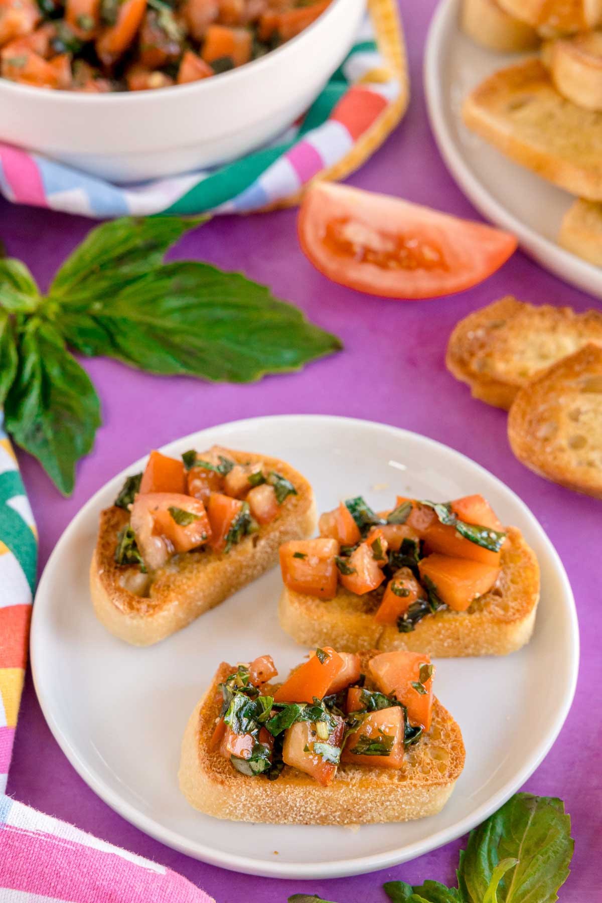 three pieces of balsamic bruschetta on a white plate