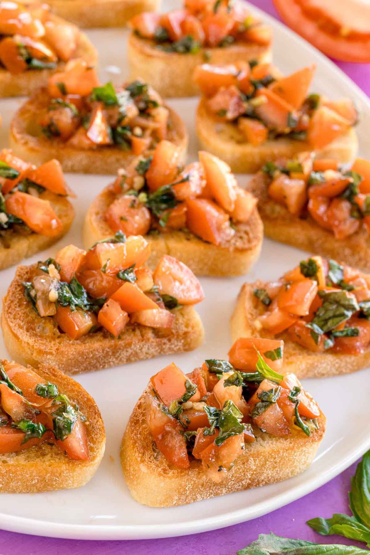 white plate with pieces of balsamic bruschetta