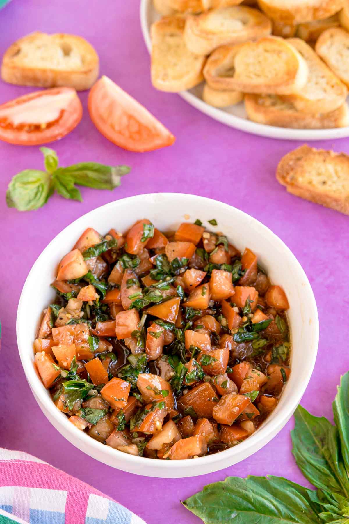 white bowl filled with tomato mixture for a balsamic bruschetta