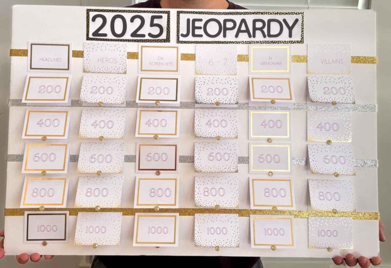 man holding a 2025 New Year's Eve jeopardy game