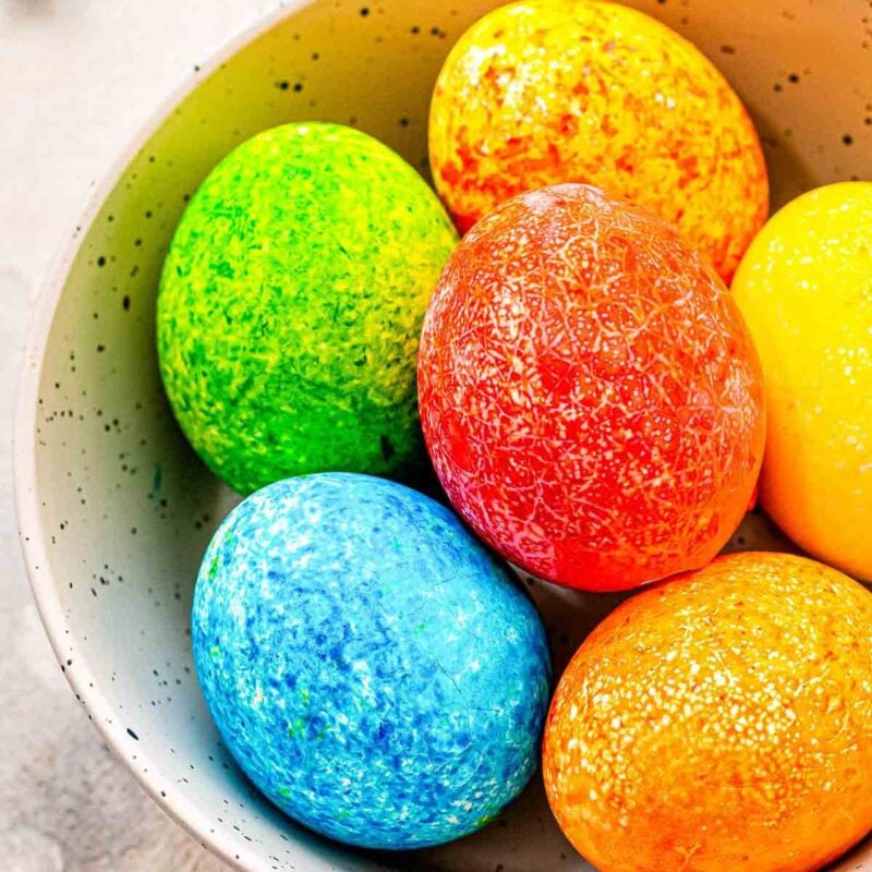 bowl of various colored easter eggs with speckled texture
