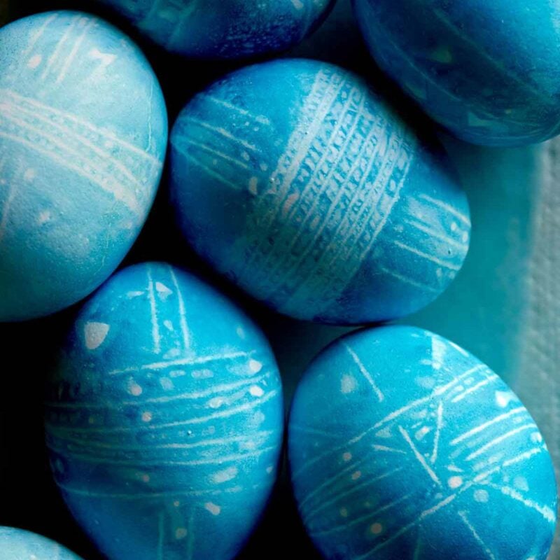blue dyed easter eggs with string patterns