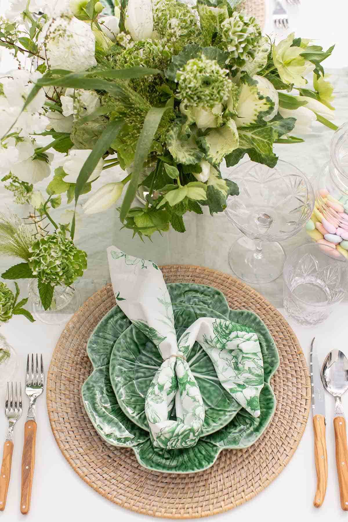 cabbage plates stacked with white and green napkin on it