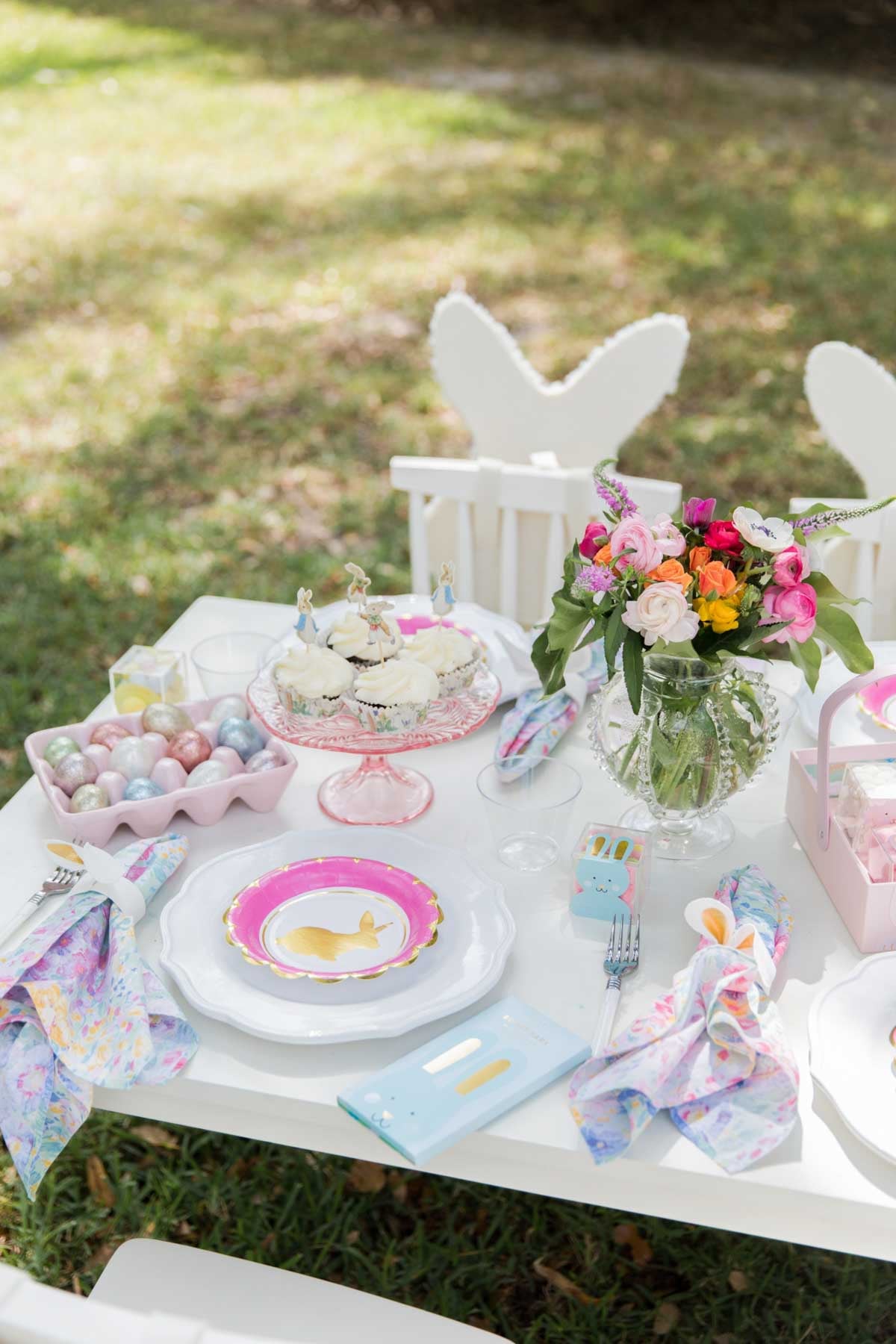 table setting with various dishware and pink bunny plate