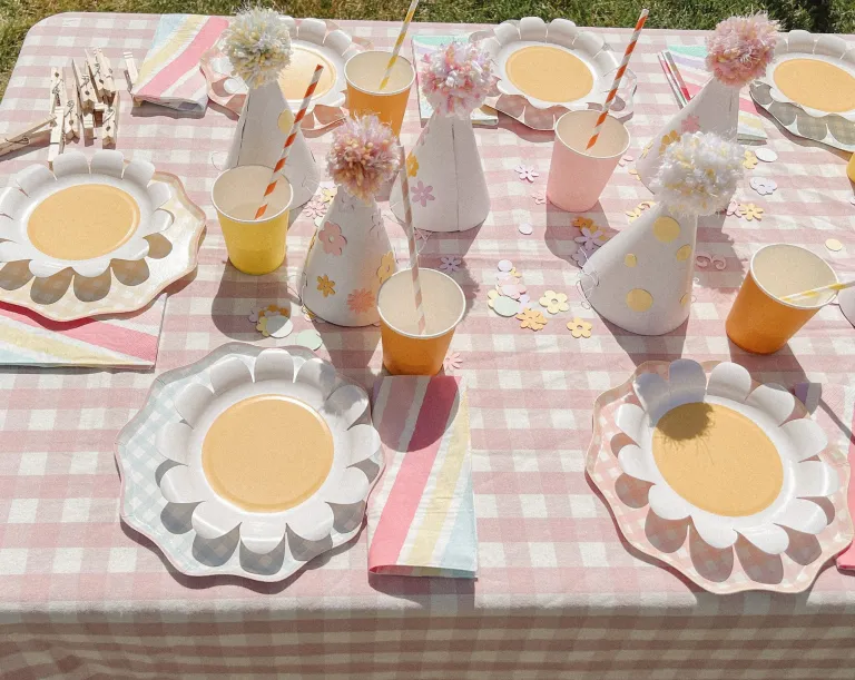 table with pink daisies and flower plates