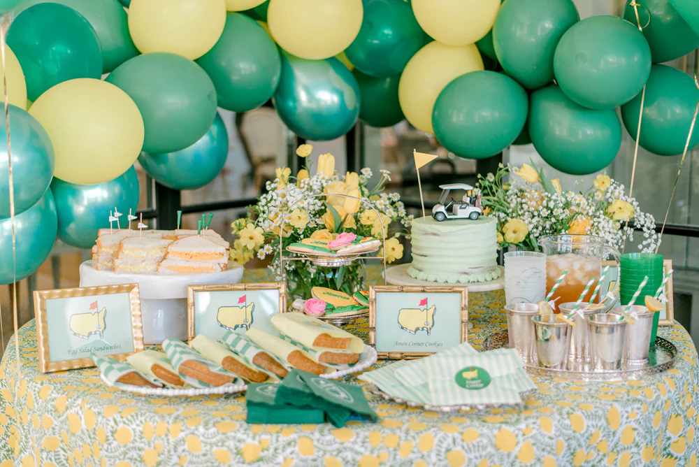 master's party table with green and yellow balloons