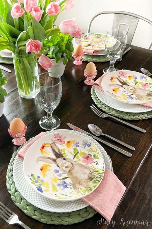 table setting with pink tulips, green placemats, and bunny plates