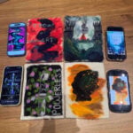felt book covers next to phones