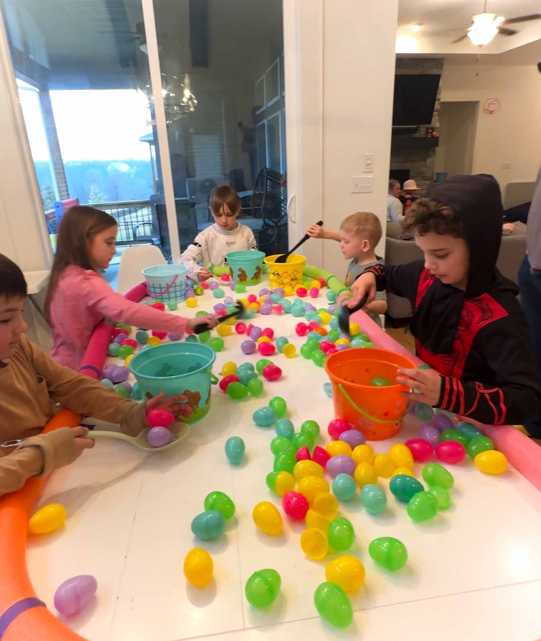 kids scooping eggs into buckets