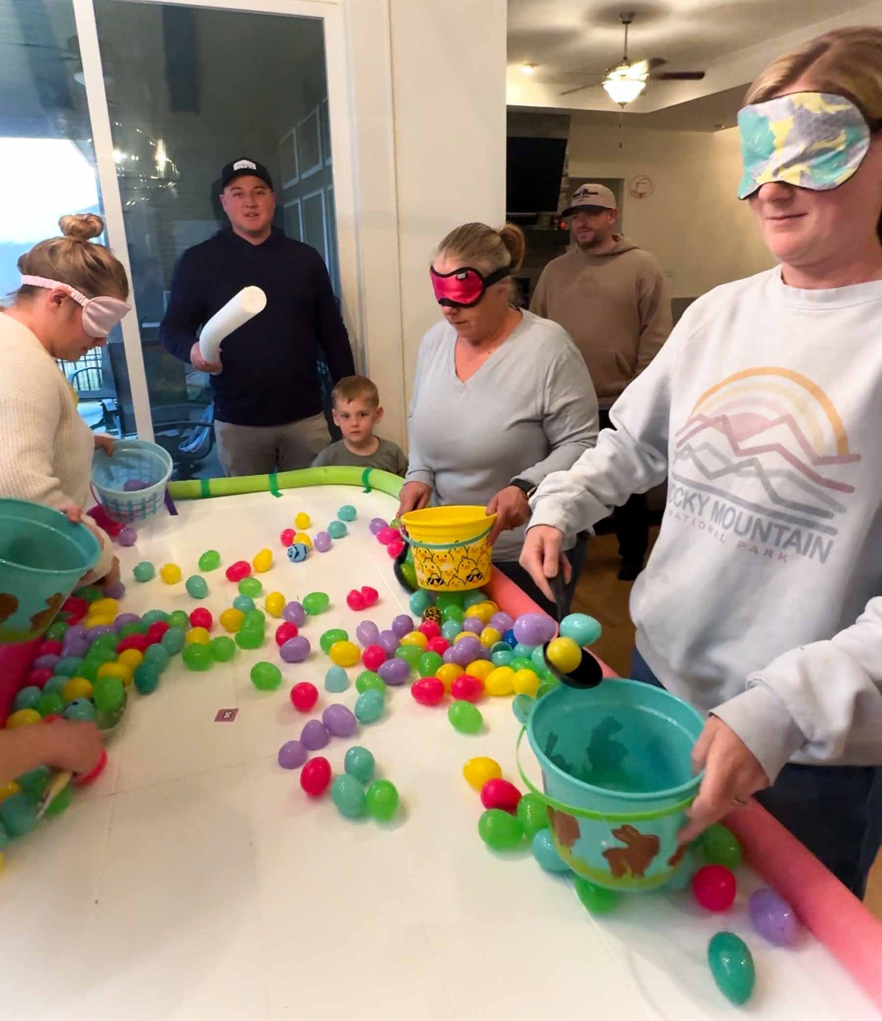 women scooping eggs into baskets while playing hungry hungry bunnies