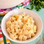 slow cooker cheesy potatoes in a white bowl