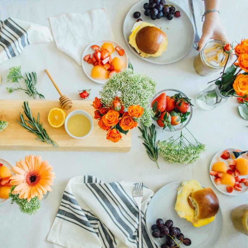 floral table setting with various brunch foods