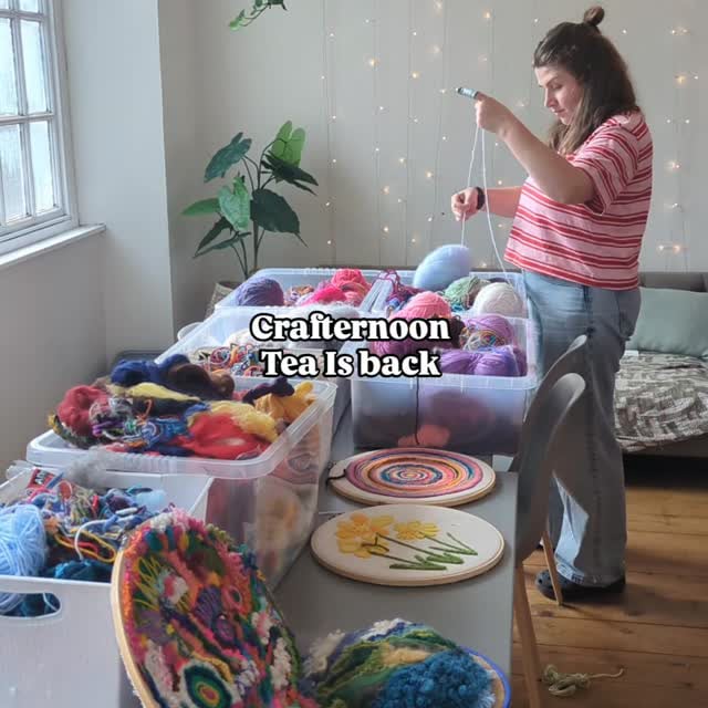 women standing at a table with various crafting supplies