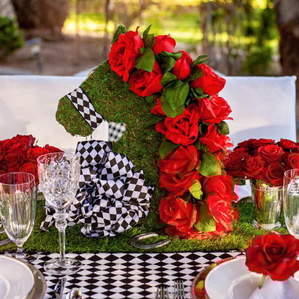 kentcuky derby table setting with a greenery horse head and roses