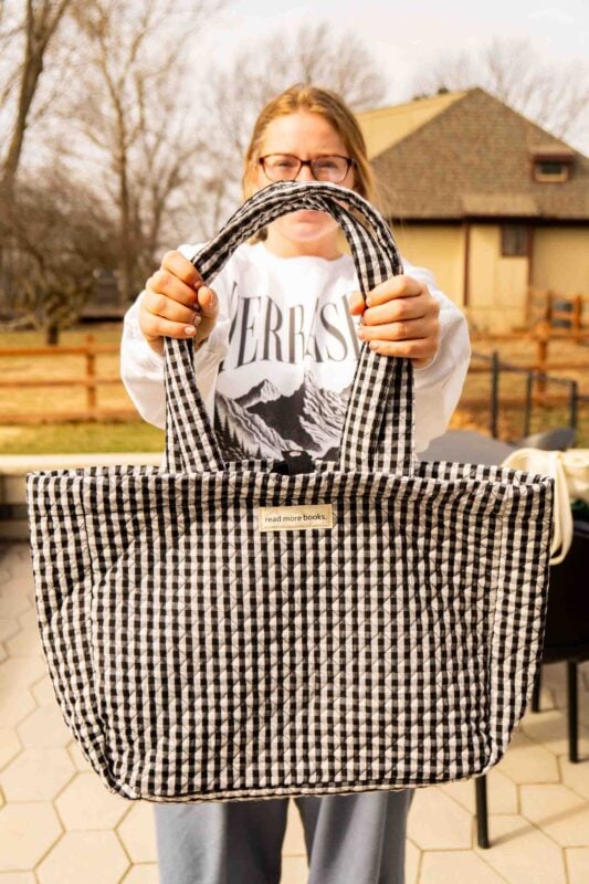 woman holding a black and white bag