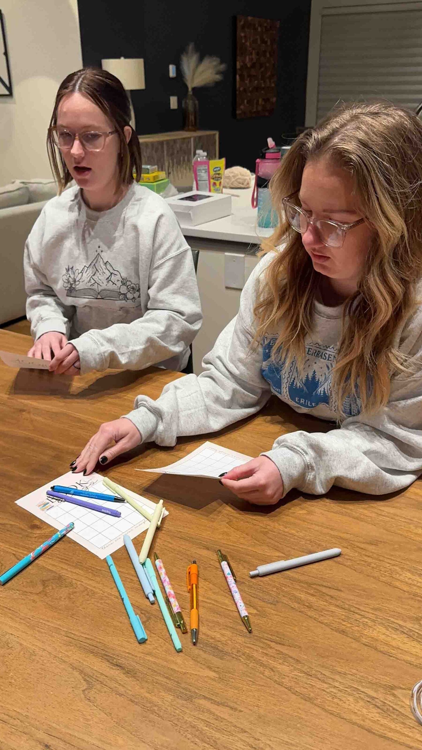 women at a table with book bingo cards