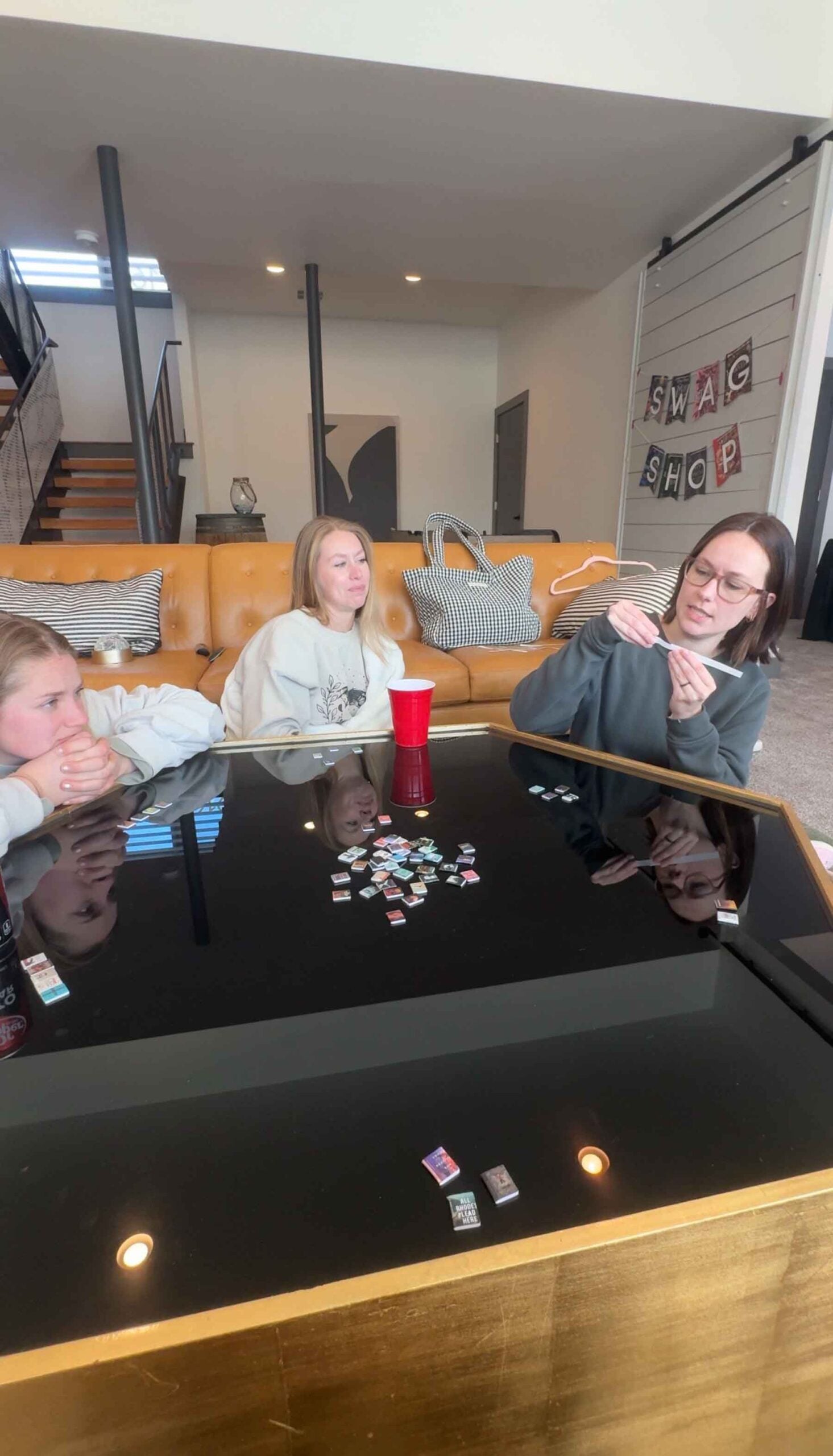 woman sitting around a table with mini books