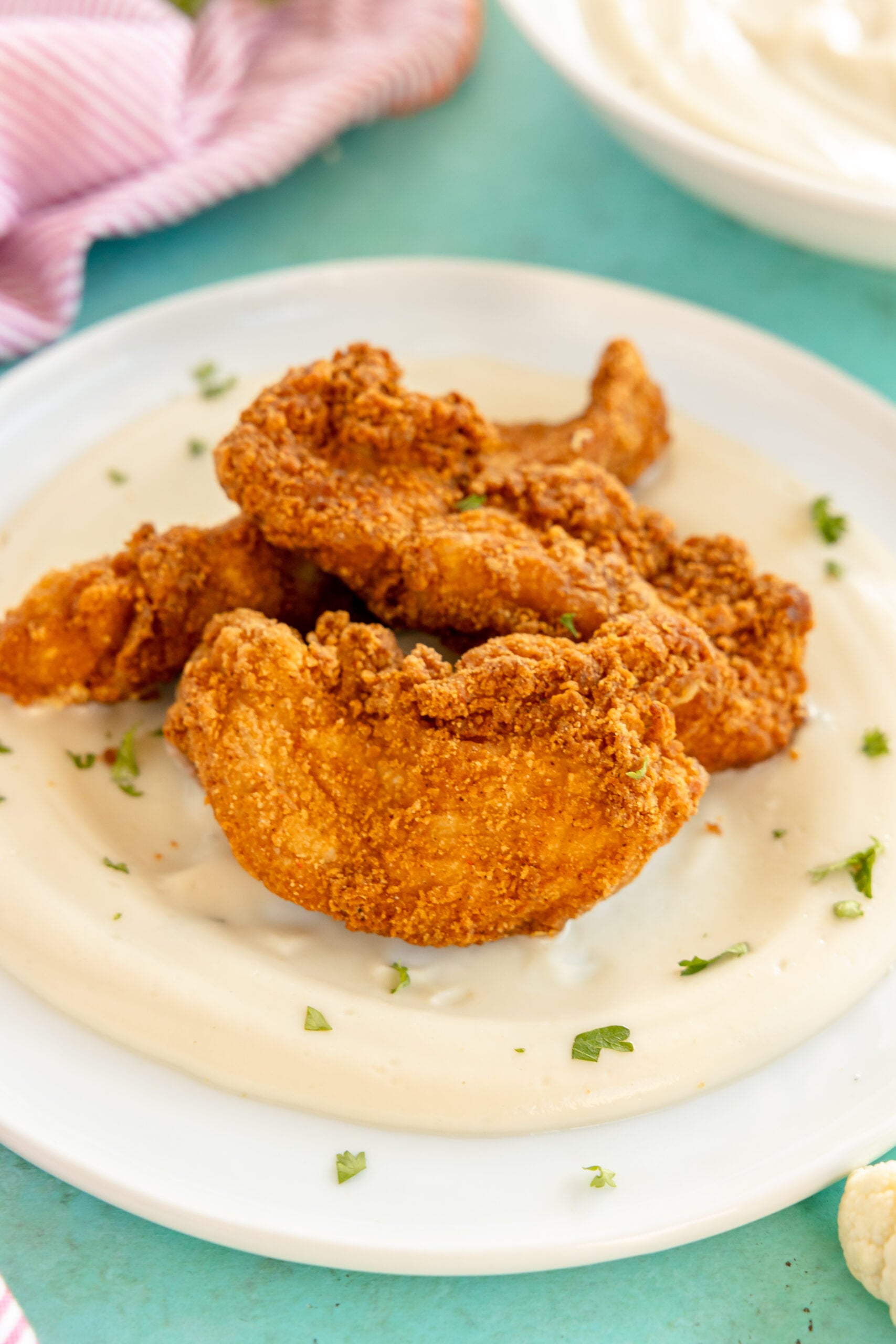 fried chicken tenders on mashed potatoes