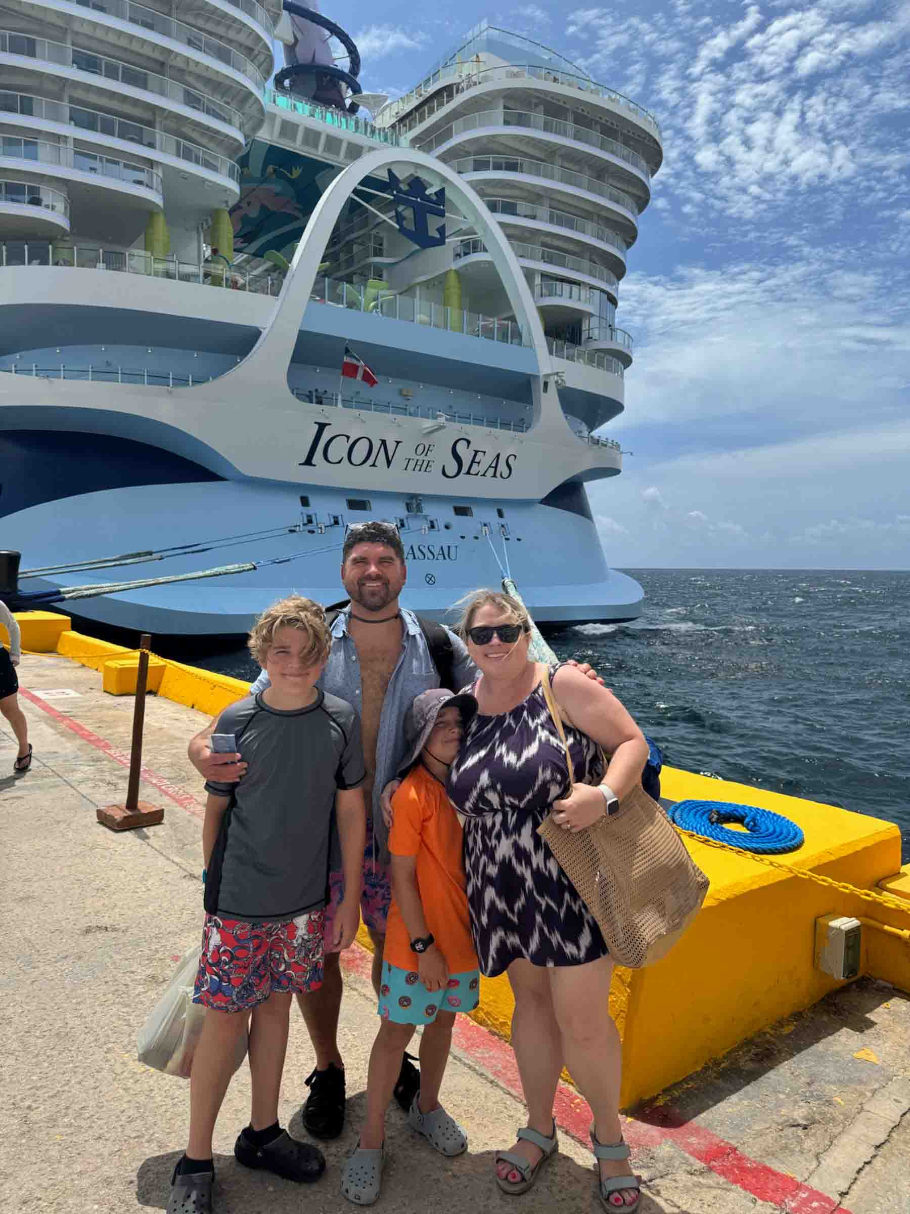 family standing in front of a cruise ship