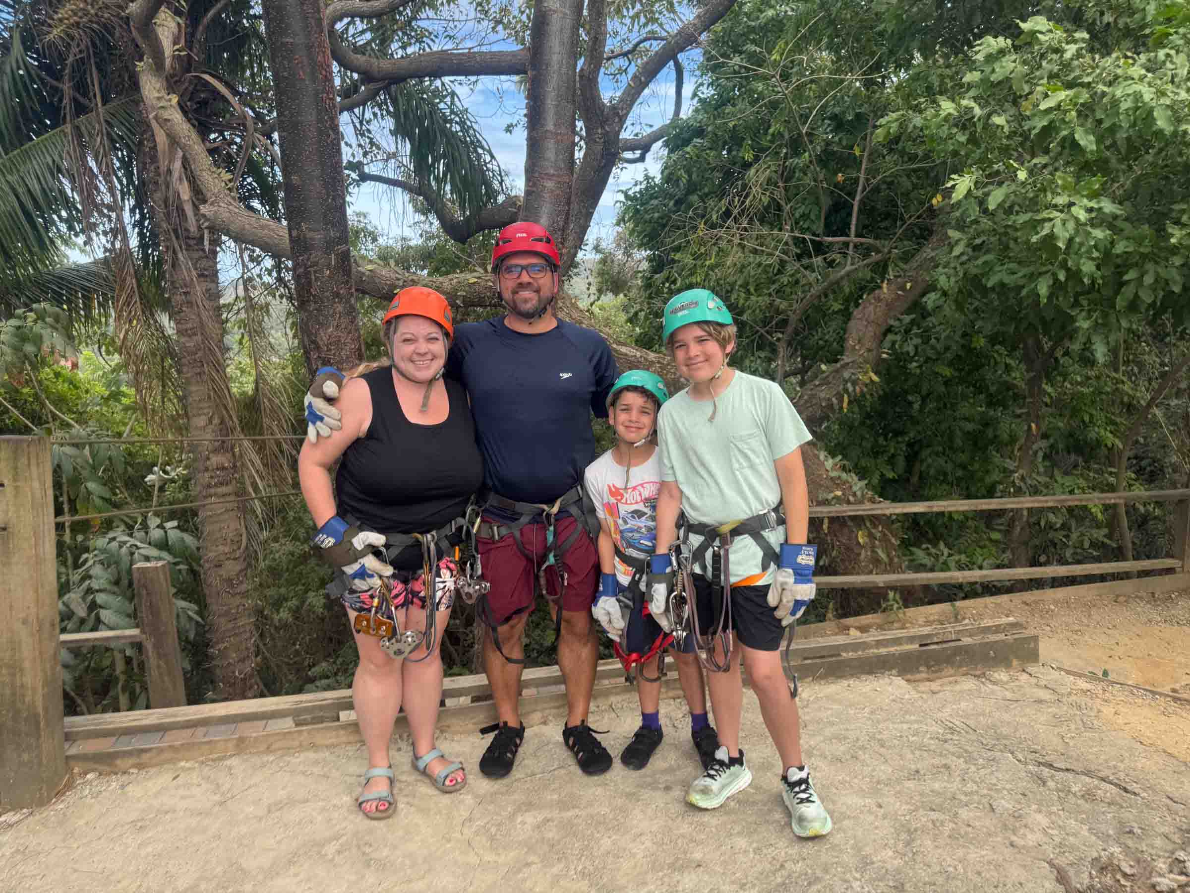 family harnessed for zip lines