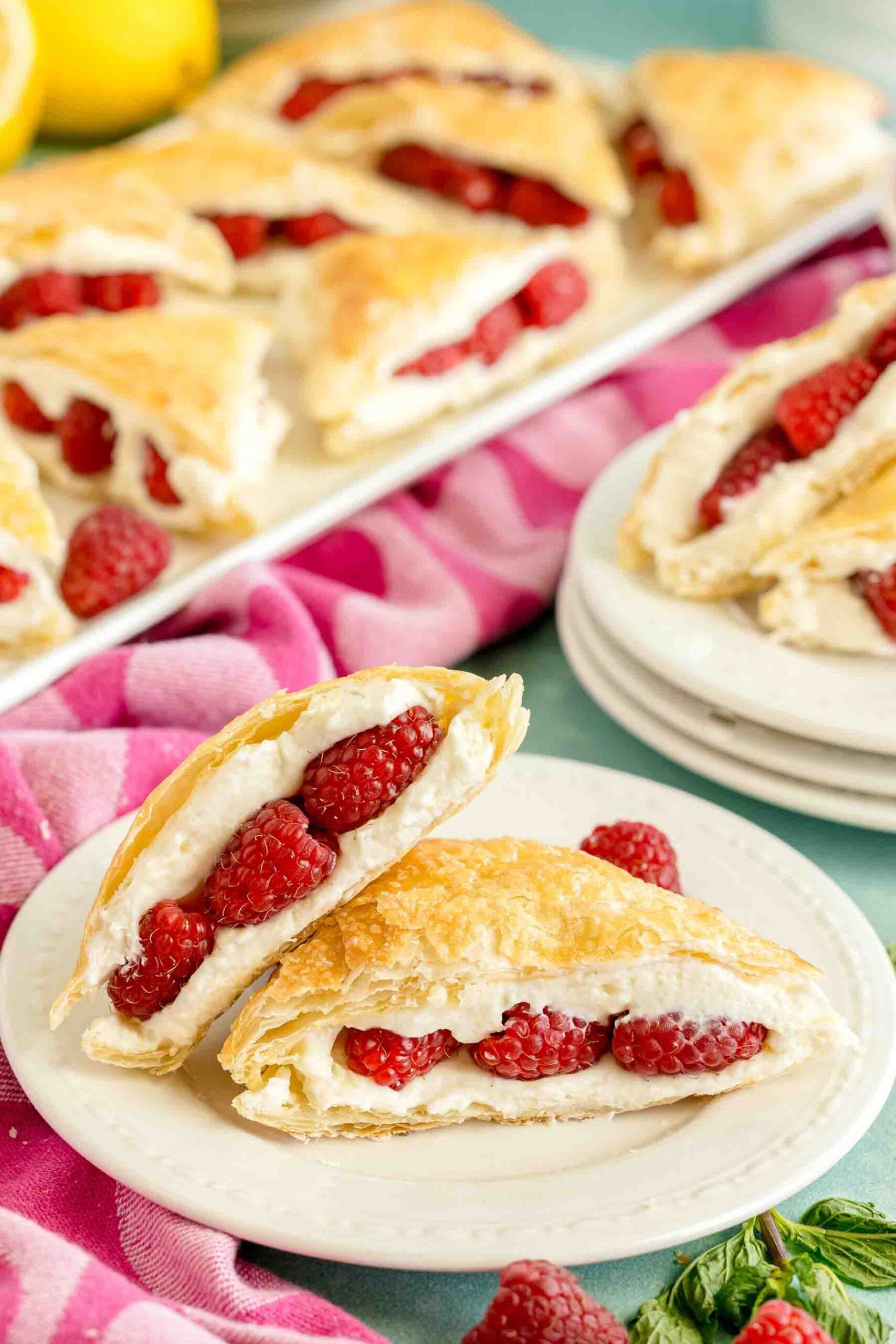 two raspberry napoleons on a white plate
