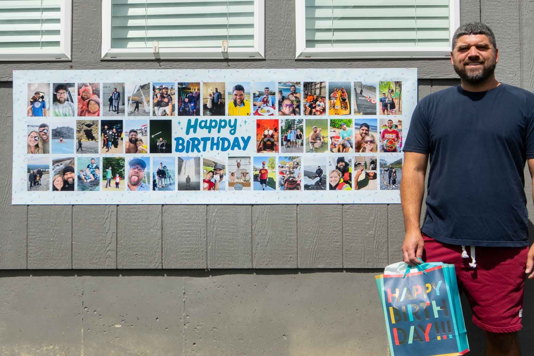 man standing next to a photo banner